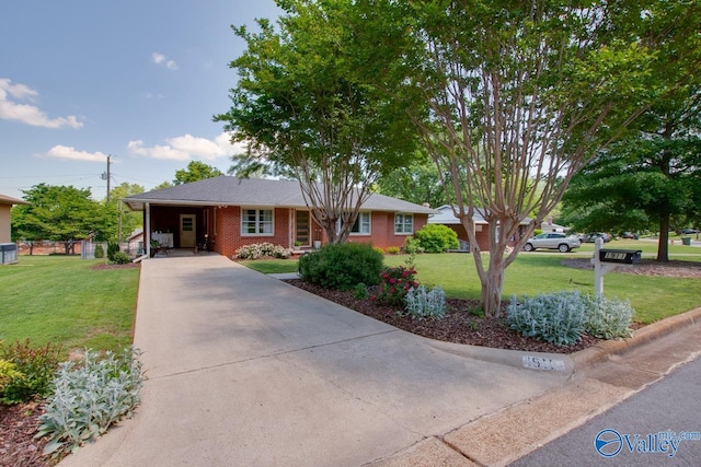 single story home featuring an attached carport, concrete driveway, brick siding, and a front yard