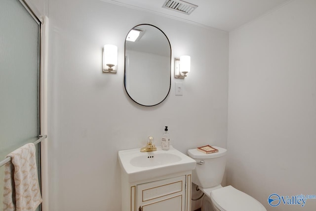 bathroom featuring visible vents, ornamental molding, toilet, and vanity