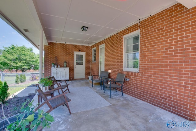 view of patio with fence and visible vents