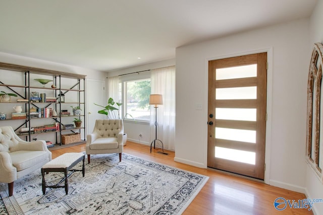 interior space with baseboards and wood finished floors