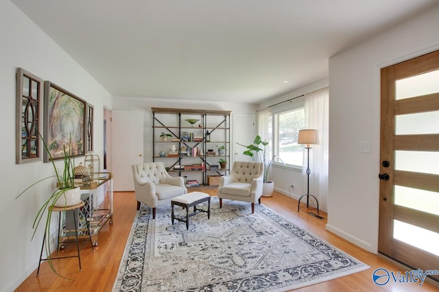 living area featuring baseboards and wood finished floors