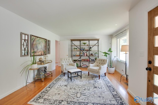 sitting room with light wood-style floors and baseboards