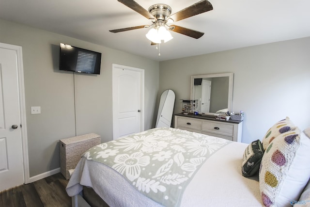 bedroom with dark wood-type flooring, baseboards, a closet, and ceiling fan