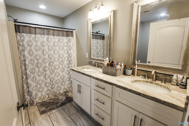 bathroom with double vanity, visible vents, a shower with shower curtain, and a sink