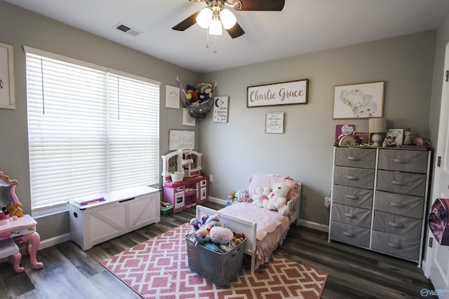 bedroom featuring dark wood finished floors, multiple windows, baseboards, and visible vents