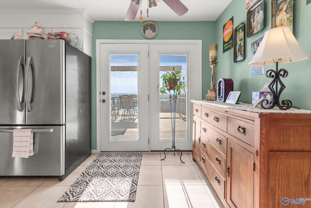 doorway to outside with light tile patterned flooring and ceiling fan