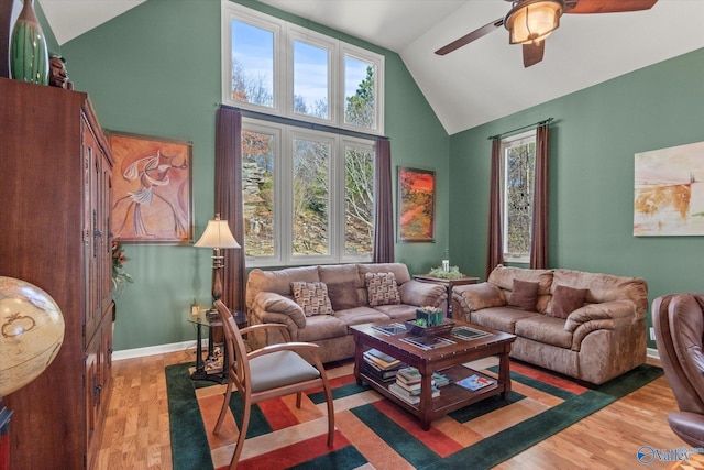 living room with ceiling fan, wood-type flooring, and lofted ceiling