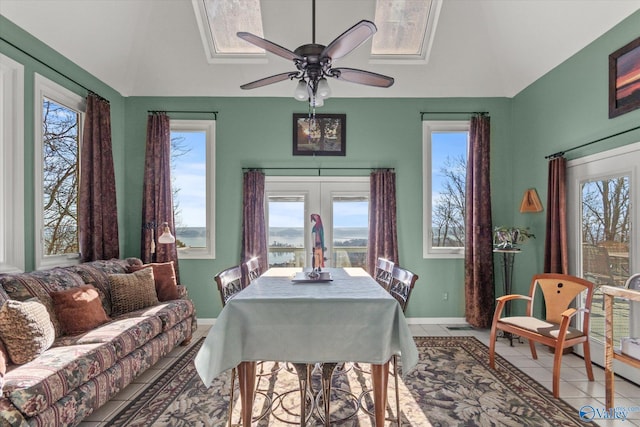 tiled dining space with plenty of natural light, ceiling fan, and french doors