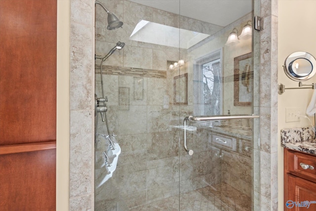 bathroom featuring walk in shower and vanity