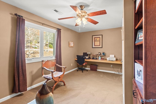 home office with ceiling fan, built in desk, and carpet floors