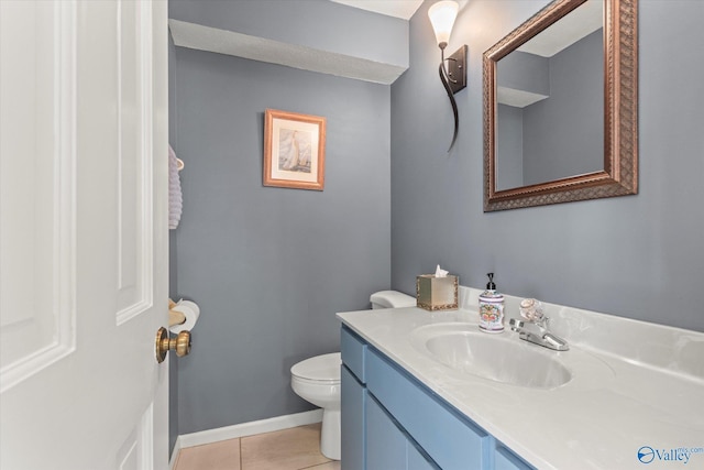 bathroom with vanity, toilet, and tile patterned floors