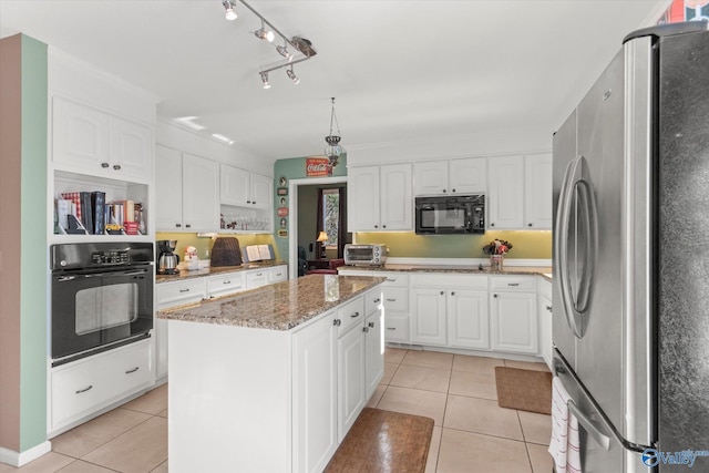 kitchen with stone countertops, white cabinetry, black appliances, and a kitchen island