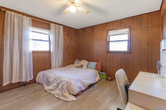 bedroom with light hardwood / wood-style flooring, multiple windows, and ceiling fan