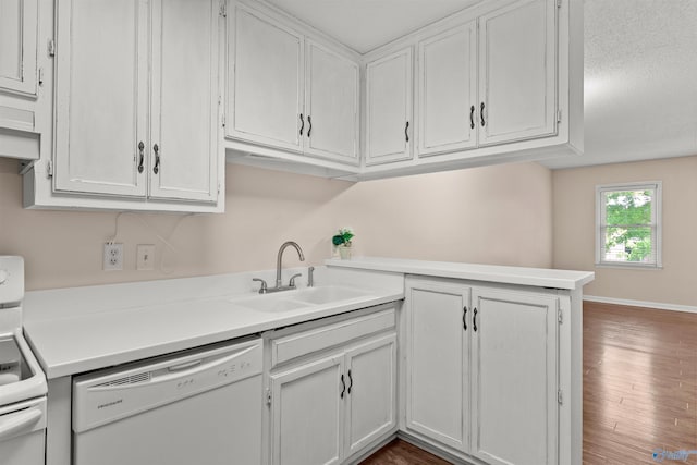 kitchen featuring white appliances, light countertops, white cabinetry, a sink, and wood finished floors