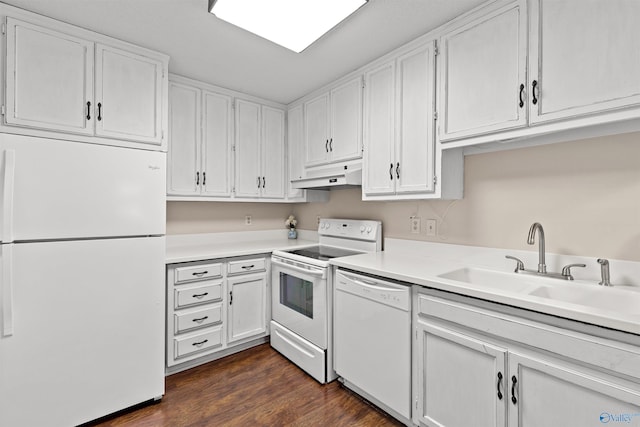 kitchen with white appliances, light countertops, white cabinetry, under cabinet range hood, and a sink