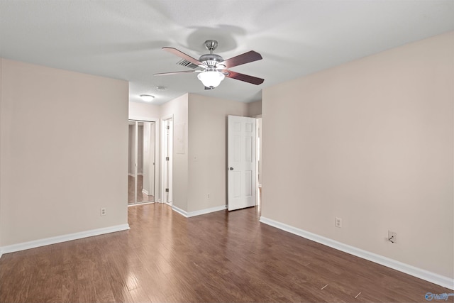 empty room featuring wood finished floors, ceiling fan, and baseboards