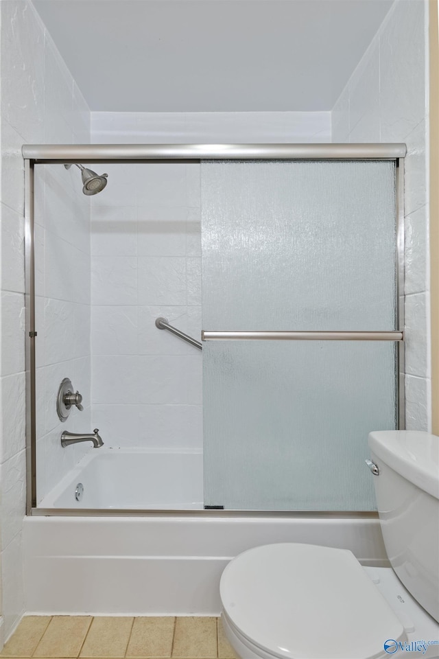 full bathroom featuring tile patterned flooring, enclosed tub / shower combo, and toilet