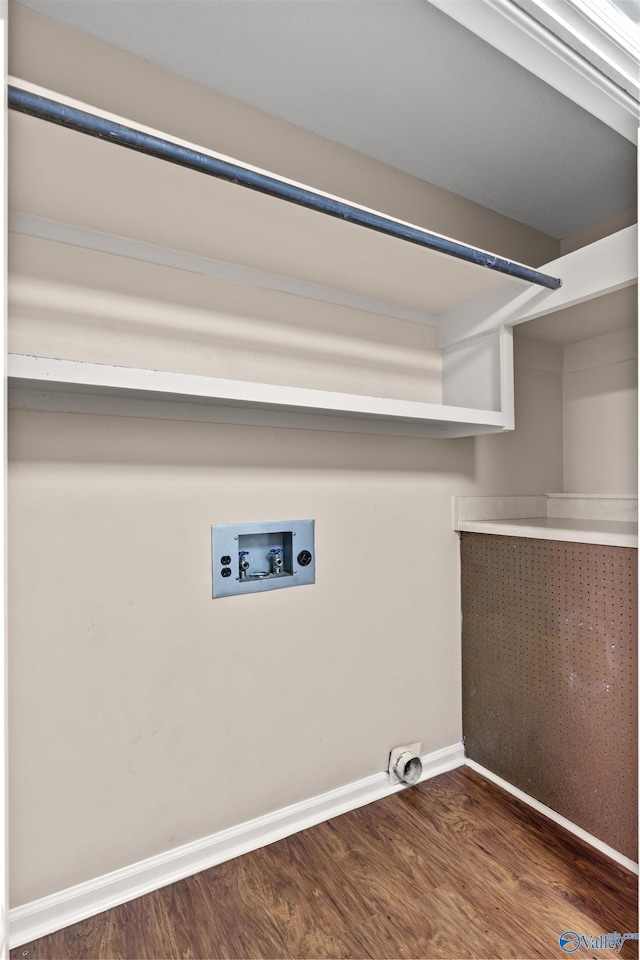laundry area featuring laundry area, hookup for a washing machine, electric dryer hookup, wood finished floors, and baseboards