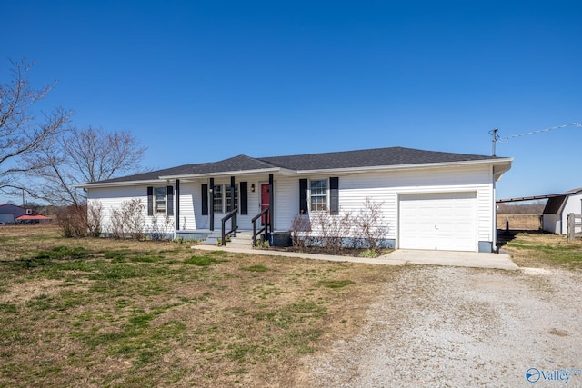 ranch-style house with covered porch, driveway, and a garage