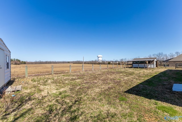 view of yard with a rural view and fence