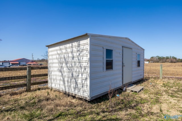 view of shed featuring fence