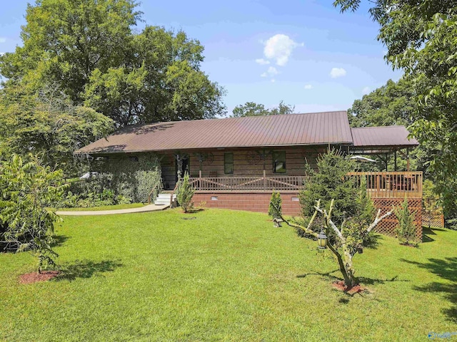 log home with a wooden deck and a front yard