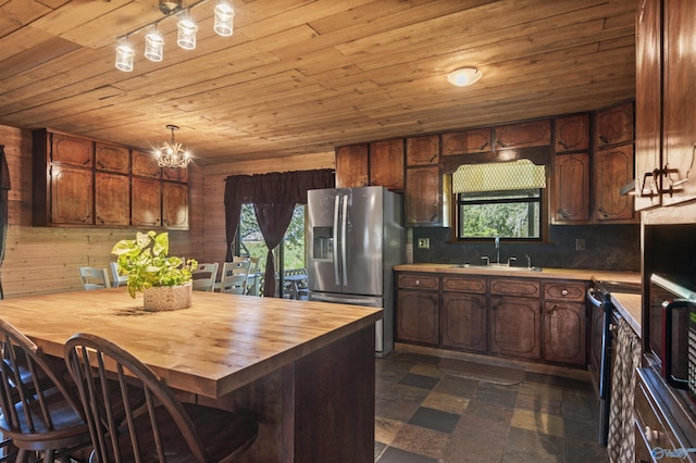 kitchen with wood counters, stainless steel fridge, sink, and wooden ceiling