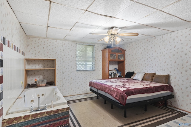 bedroom with a drop ceiling and ceiling fan