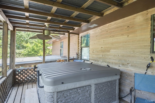 wooden terrace featuring ceiling fan and a jacuzzi