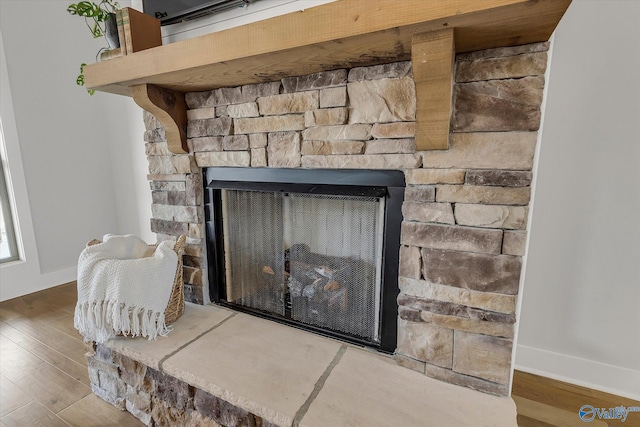 interior details featuring hardwood / wood-style floors and a fireplace