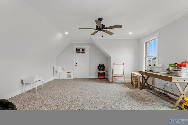 interior space featuring ceiling fan, vaulted ceiling, and carpet