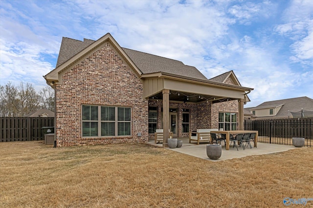 back of house with ceiling fan, a patio, and a lawn