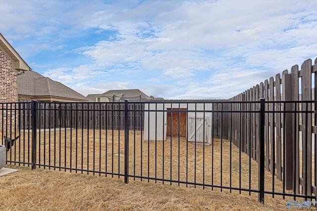 view of gate featuring a yard