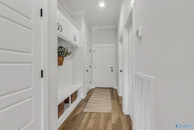 mudroom with ornamental molding and hardwood / wood-style floors