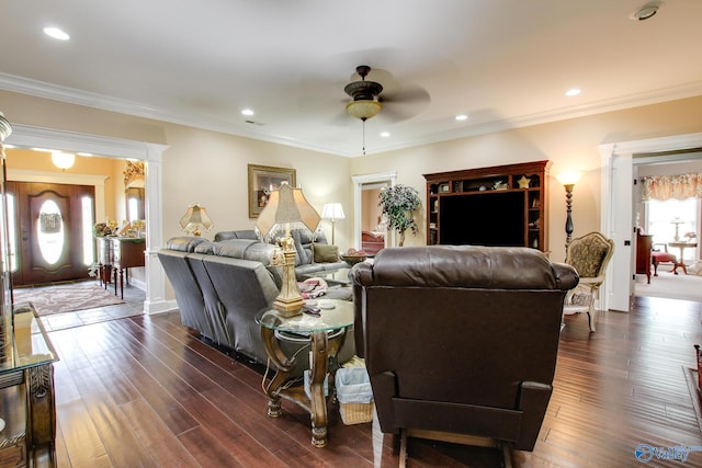 living area featuring dark wood-style floors, a ceiling fan, and ornamental molding