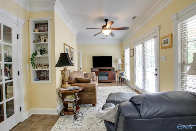 tiled living area featuring visible vents, baseboards, crown molding, and a ceiling fan