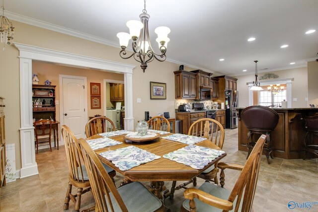 dining room featuring decorative columns, ornamental molding, recessed lighting, a notable chandelier, and washer / clothes dryer