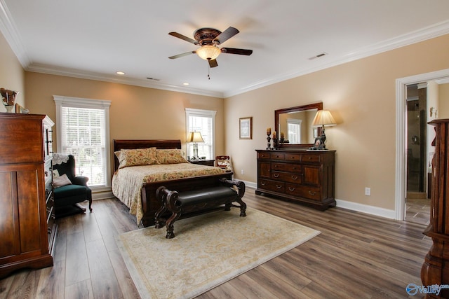 bedroom featuring visible vents, baseboards, dark wood-style flooring, ceiling fan, and ornamental molding