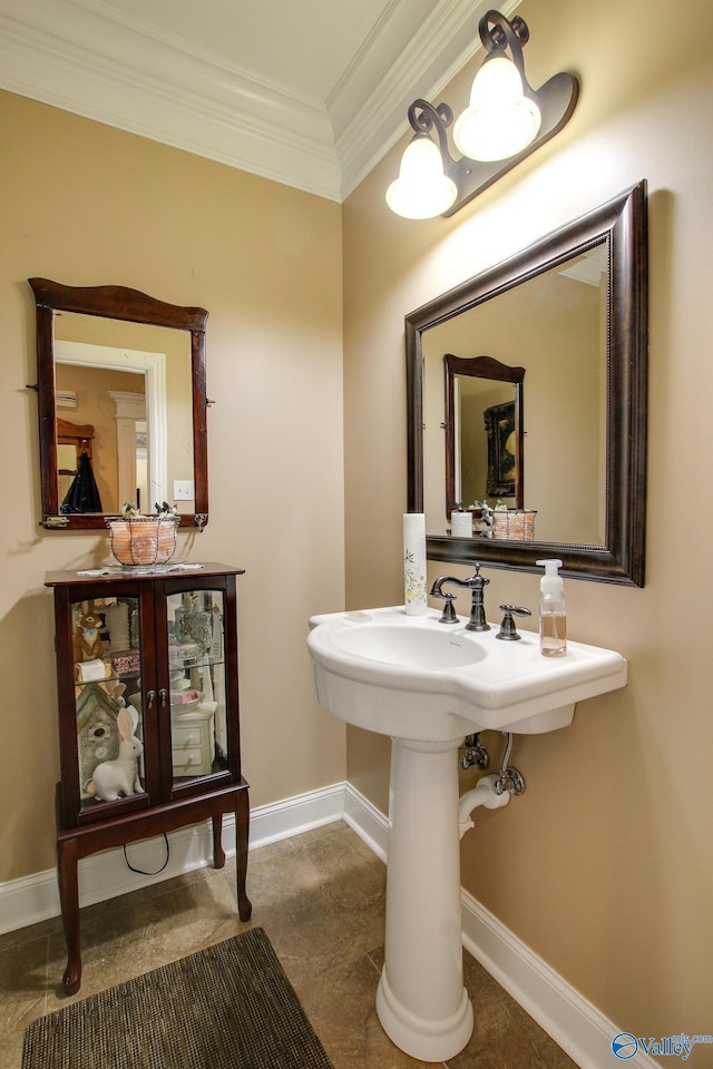bathroom with baseboards and ornamental molding
