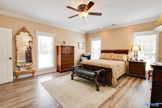 bedroom with visible vents, multiple windows, light wood-type flooring, and ornamental molding