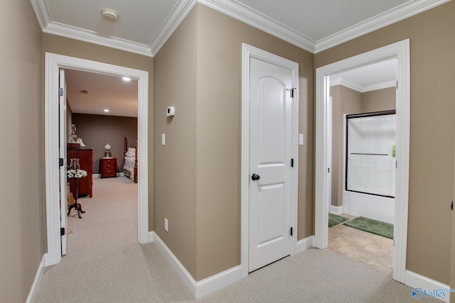 hallway with crown molding, baseboards, and carpet floors