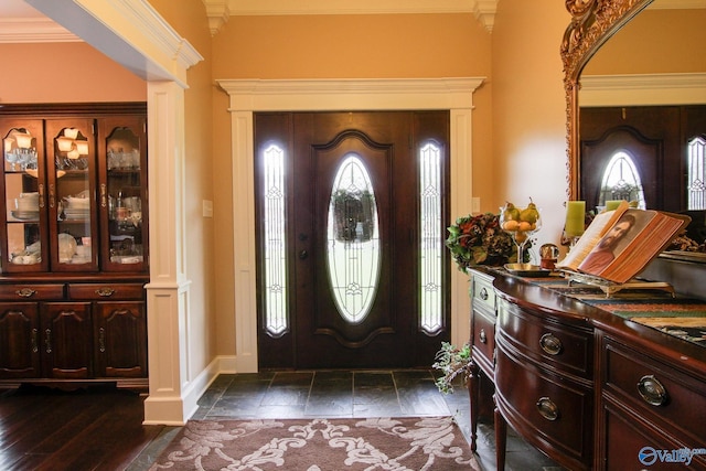 entrance foyer featuring baseboards, dark wood-style flooring, and ornamental molding