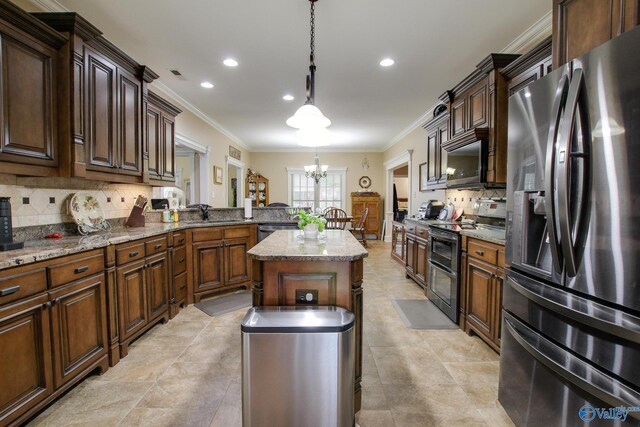 kitchen featuring decorative backsplash, an inviting chandelier, appliances with stainless steel finishes, and ornamental molding