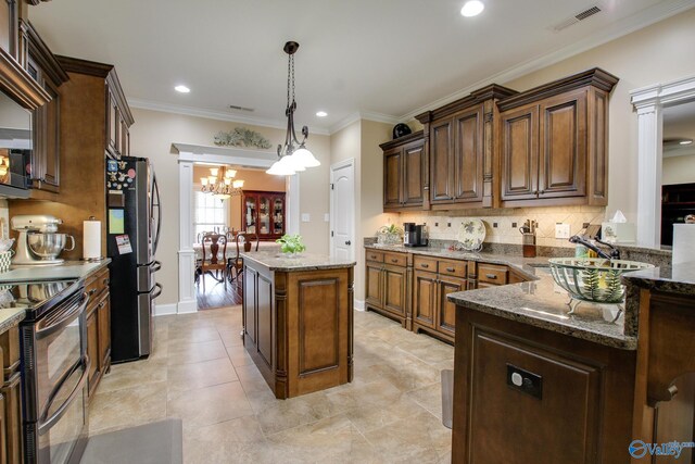 kitchen with dark stone countertops, visible vents, a sink, appliances with stainless steel finishes, and a center island