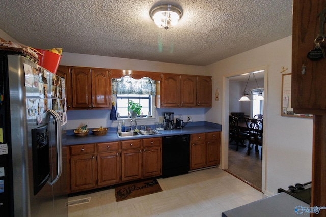 kitchen with sink, black dishwasher, stainless steel fridge with ice dispenser, and a textured ceiling