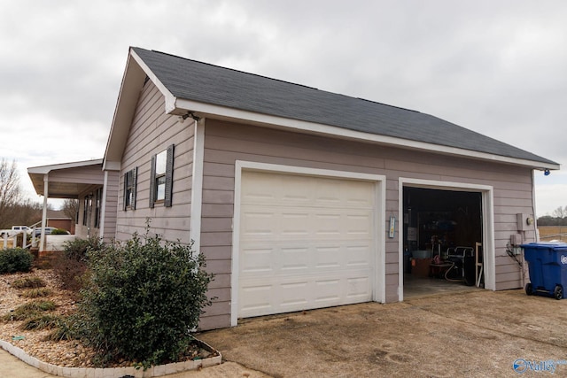 view of side of property with a garage and an outdoor structure