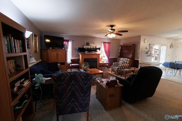 living room with plenty of natural light, a textured ceiling, and carpet