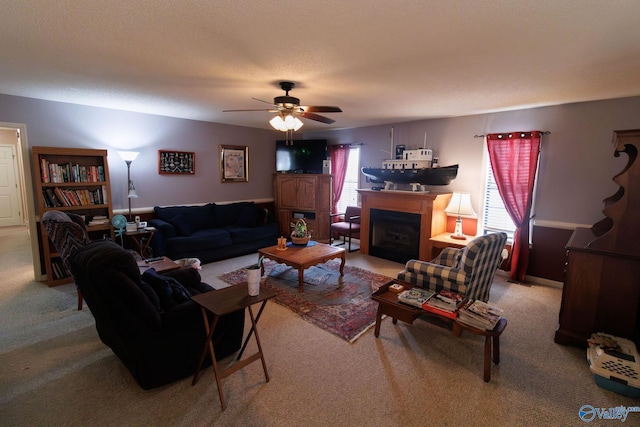 carpeted living room with a textured ceiling and ceiling fan