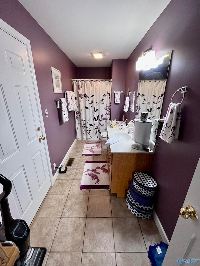 bathroom with tile patterned floors, toilet, and vanity