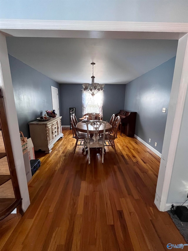 dining space featuring a chandelier and dark hardwood / wood-style flooring